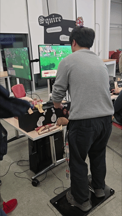 couple people playing Squire, an alt-controller game